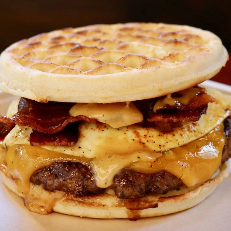 Brunch Burger on waffle buns with a fried egg and bacon