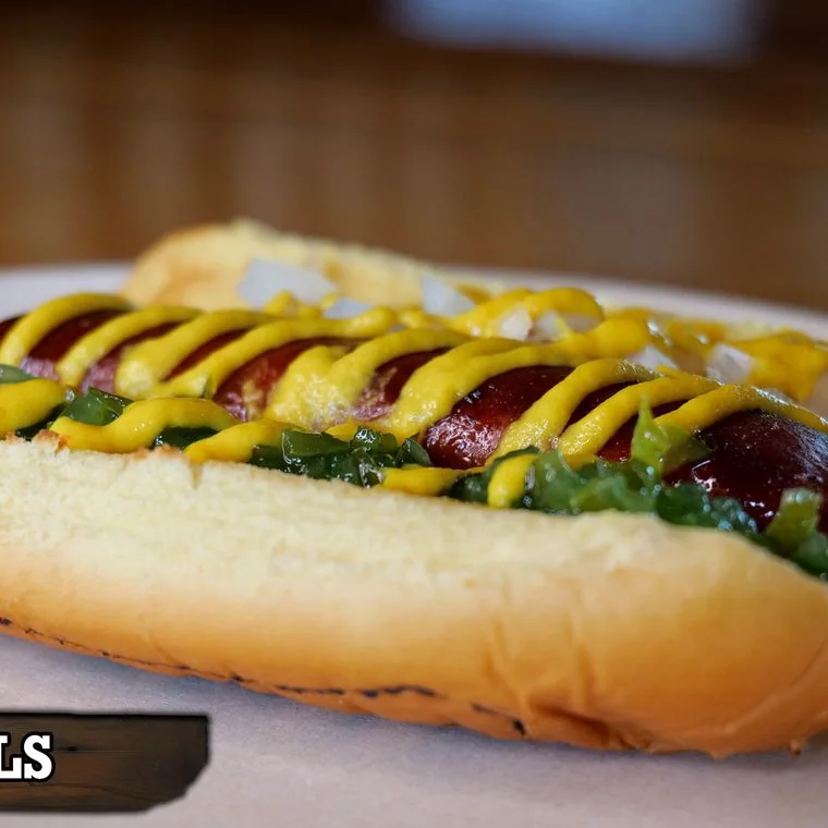 Wells wagyu beef dog with sweet relish, diced onions and mustard