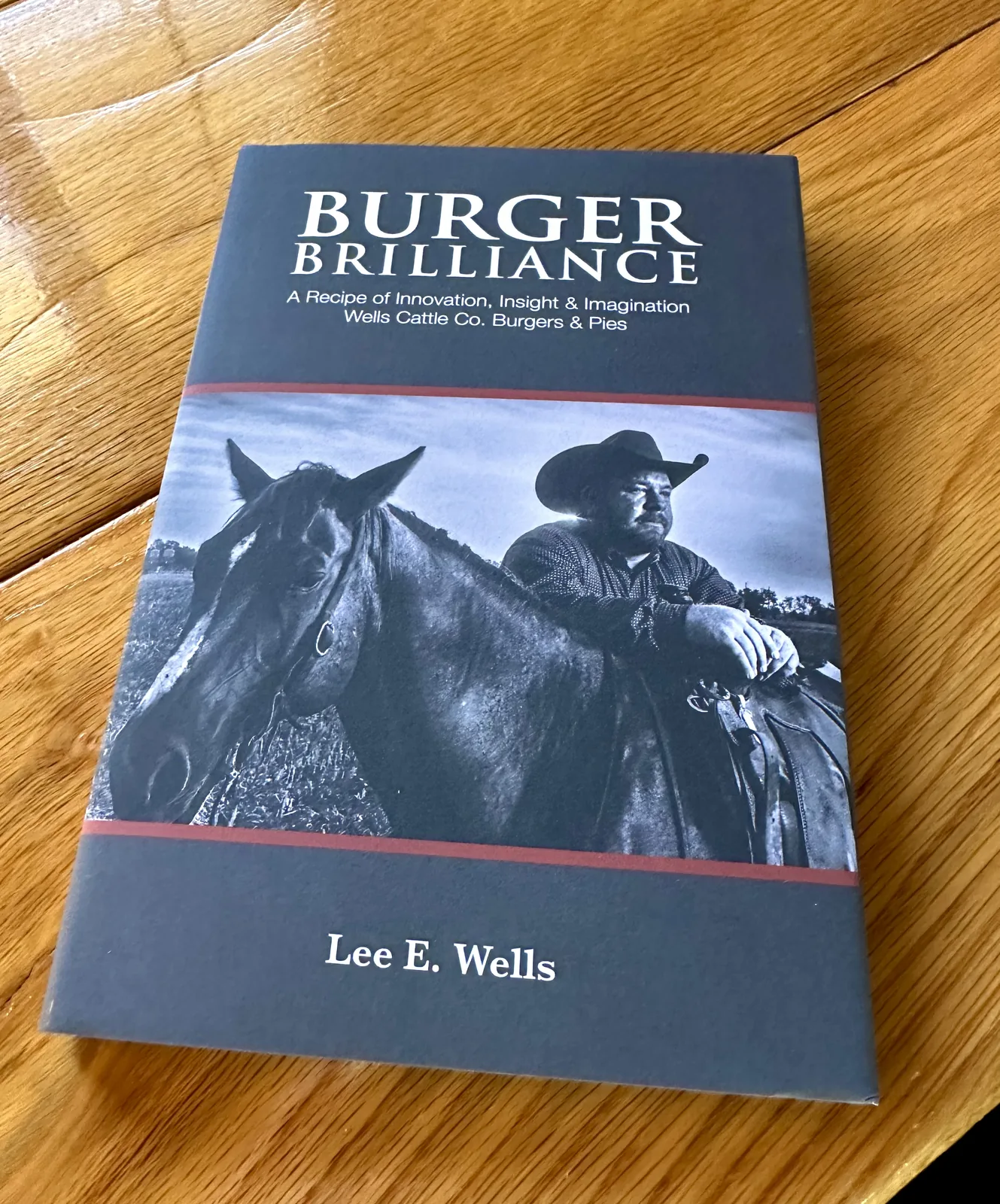 The Burger Brilliance cover on a wood table