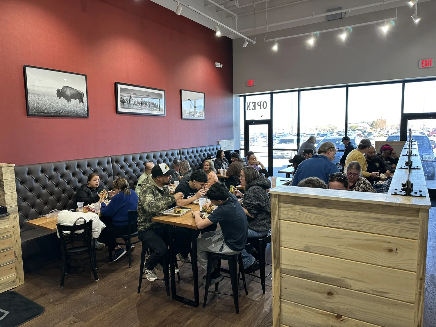 A full dining room at Wells Burgers Express, guests at every table