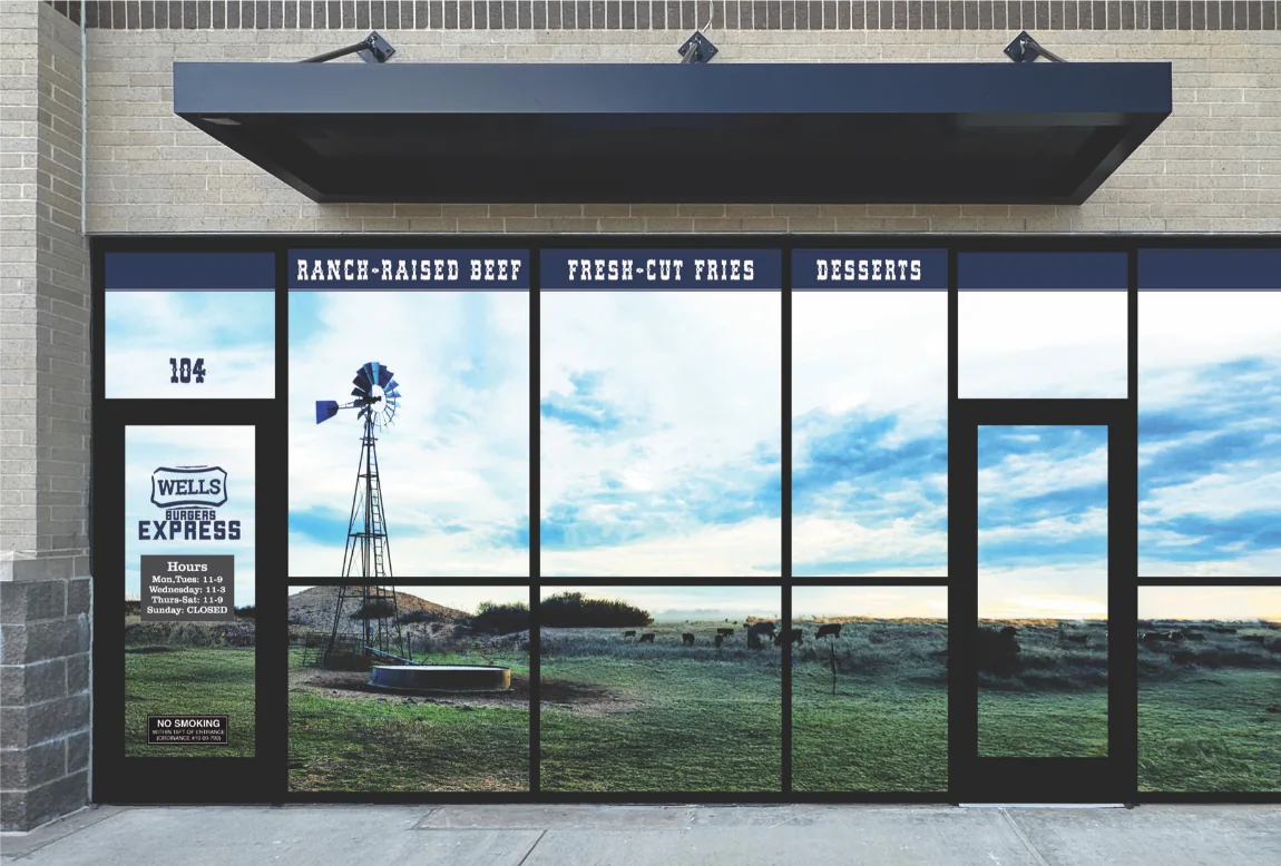 The Wells Burgers Express storefront on I-30, its windows printed with a Texas pasture